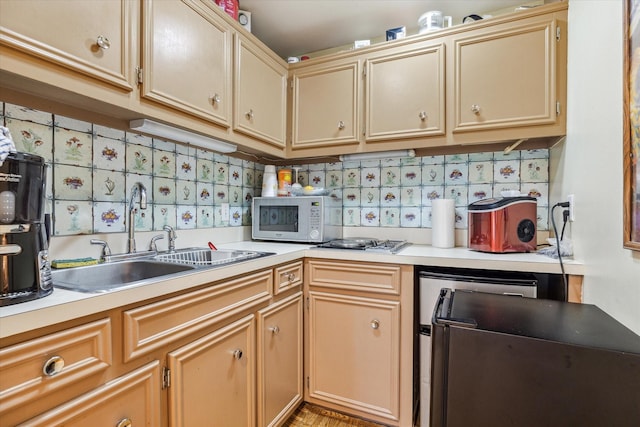 kitchen featuring white microwave, refrigerator, a sink, light countertops, and tasteful backsplash