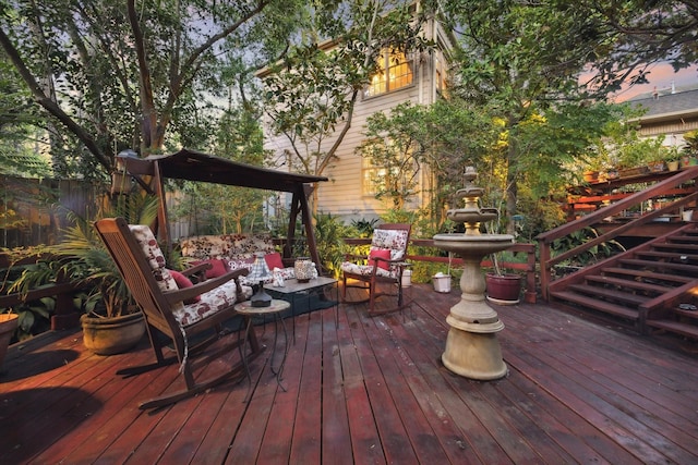 wooden terrace featuring fence and outdoor lounge area