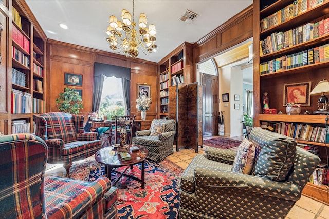 living area featuring wood walls, visible vents, built in features, bookshelves, and ornamental molding