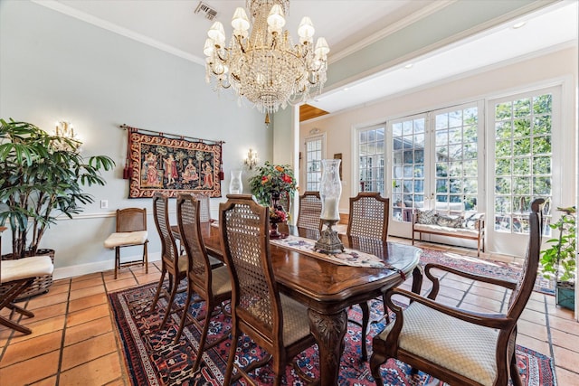 dining space with light tile patterned floors, a notable chandelier, visible vents, baseboards, and crown molding