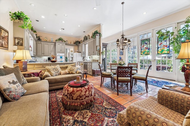 living room featuring light tile patterned floors, french doors, crown molding, and an inviting chandelier