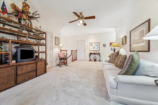 living room featuring light carpet, ceiling fan, and ornamental molding