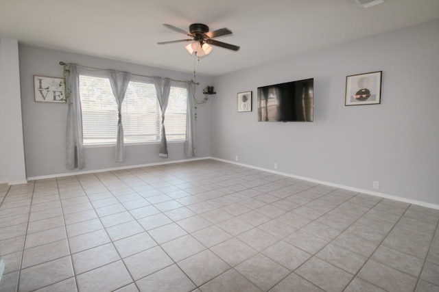 tiled spare room with ceiling fan