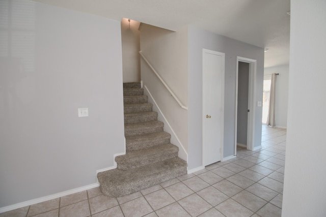 stairway featuring tile patterned flooring