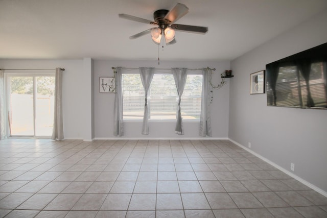 spare room featuring light tile patterned floors and ceiling fan