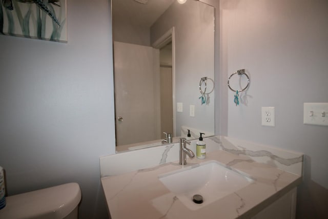 bathroom with vanity and toilet