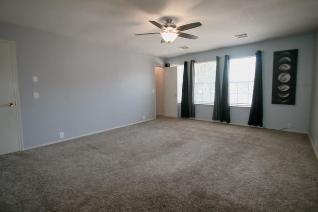 unfurnished room with ceiling fan and carpet flooring