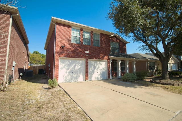 view of front property with a garage and cooling unit