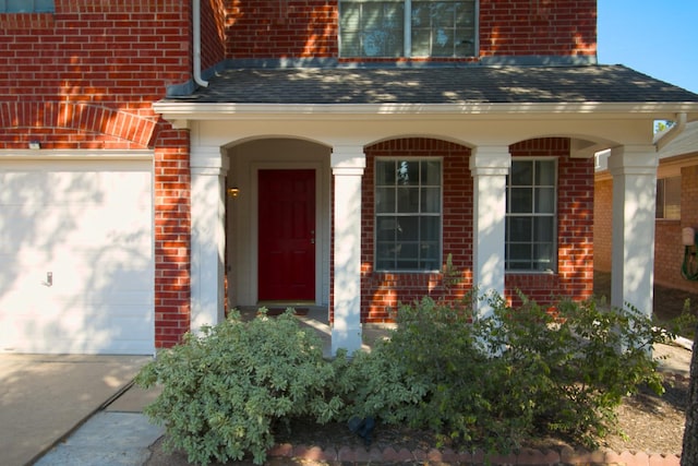 doorway to property with a garage