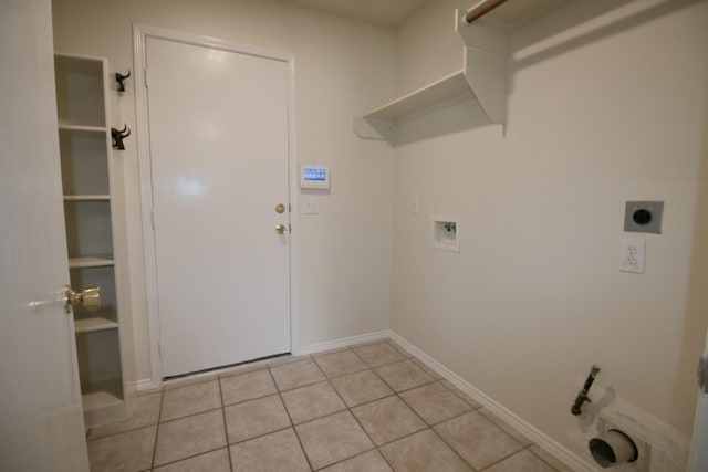 washroom with electric dryer hookup, washer hookup, and light tile patterned floors