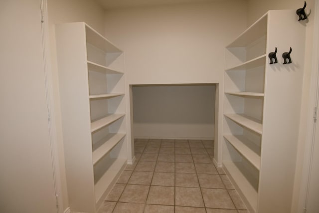 spacious closet featuring light tile patterned floors