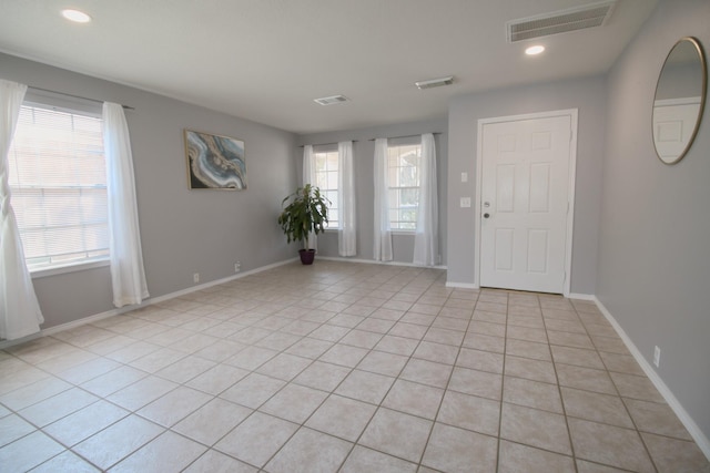 entrance foyer featuring a wealth of natural light and light tile patterned floors