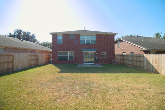 back of house featuring a lawn