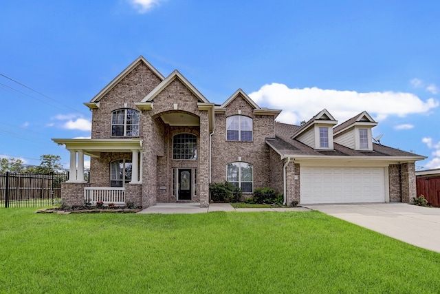 view of front facade featuring a front lawn, covered porch, and a garage