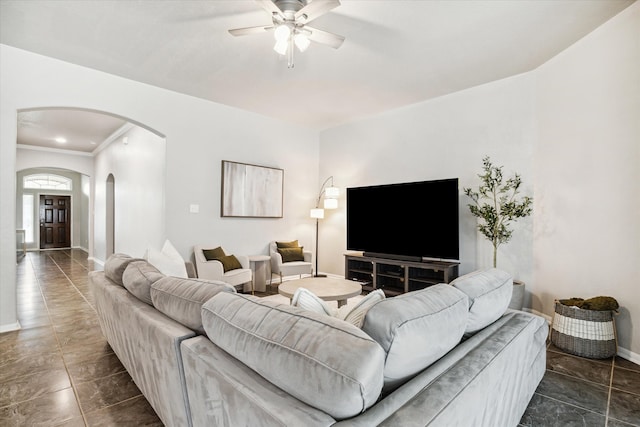 living room featuring crown molding and ceiling fan