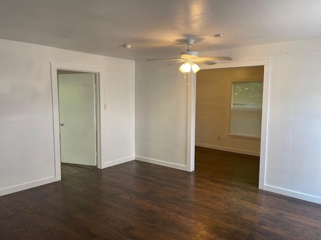 spare room featuring ceiling fan and dark hardwood / wood-style floors