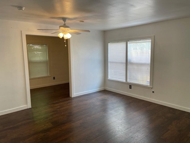 spare room featuring dark wood-type flooring and ceiling fan