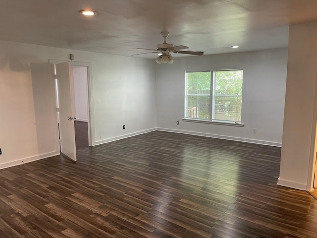 spare room with dark hardwood / wood-style floors and ceiling fan