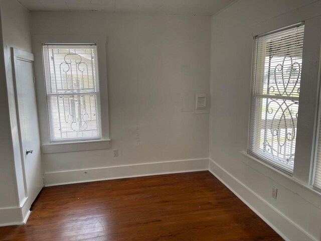 709 N Loop, Houston, TX 77022 - empty room featuring dark wood-style floors and baseboards