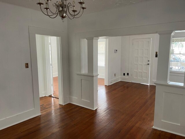 709 N Loop, Houston, TX 77022 - entrance foyer with dark wood-style flooring, a chandelier, baseboards, and a decorative wall