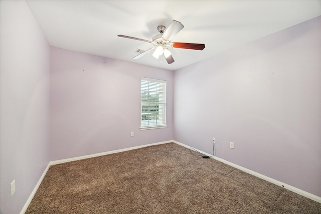 carpeted spare room featuring ceiling fan