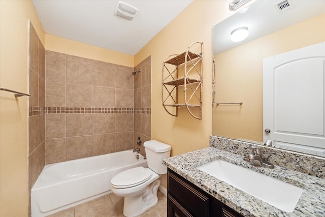 full bathroom with tiled shower / bath, vanity, toilet, and tile patterned flooring