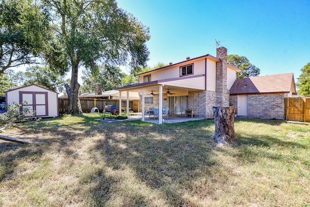 back of property featuring a lawn, ceiling fan, and a patio area