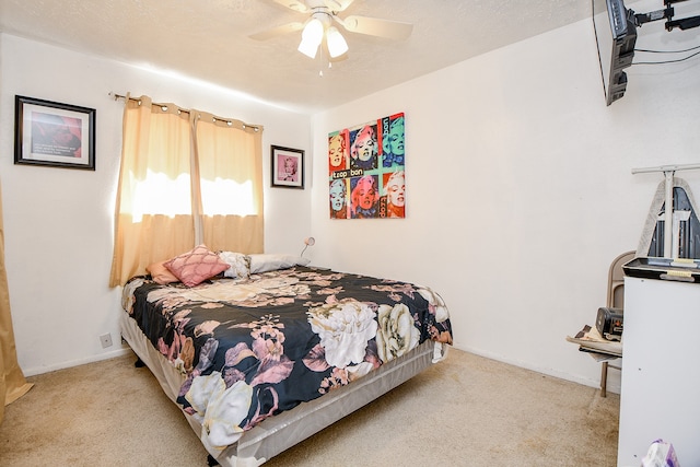 bedroom featuring ceiling fan and light carpet