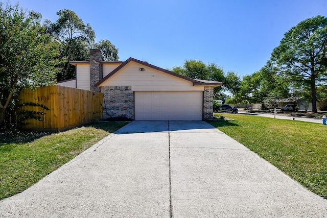 view of front of home featuring a front yard and a garage