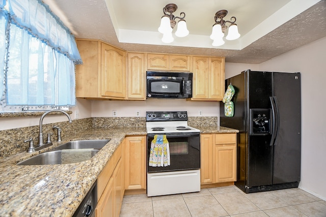 kitchen with a raised ceiling, light brown cabinetry, sink, and black appliances