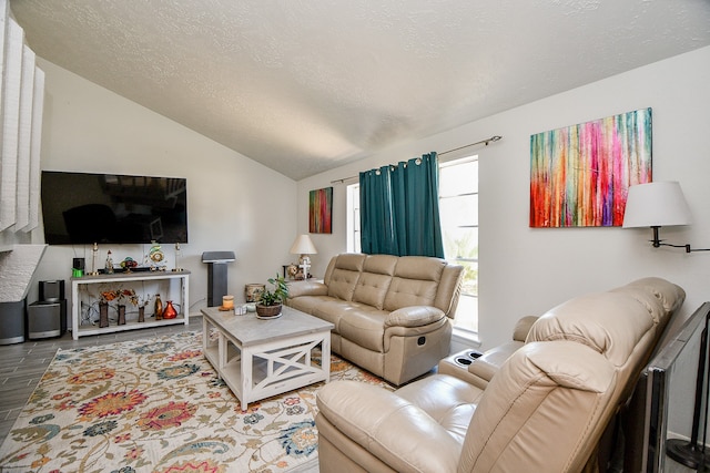 living room with a textured ceiling and vaulted ceiling