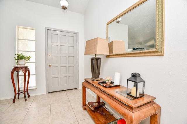 tiled entrance foyer featuring vaulted ceiling