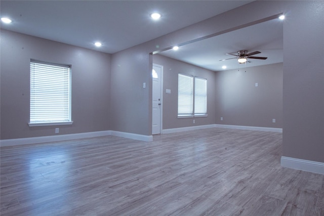 empty room featuring hardwood / wood-style flooring and ceiling fan