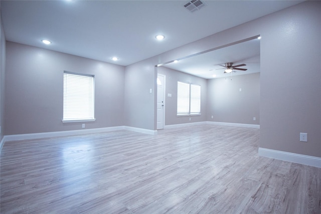 empty room with light hardwood / wood-style flooring and ceiling fan