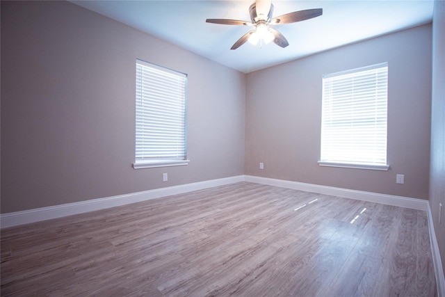 empty room with ceiling fan and light hardwood / wood-style floors