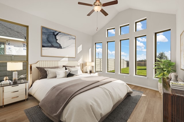 bedroom featuring light hardwood / wood-style flooring, ceiling fan, and lofted ceiling