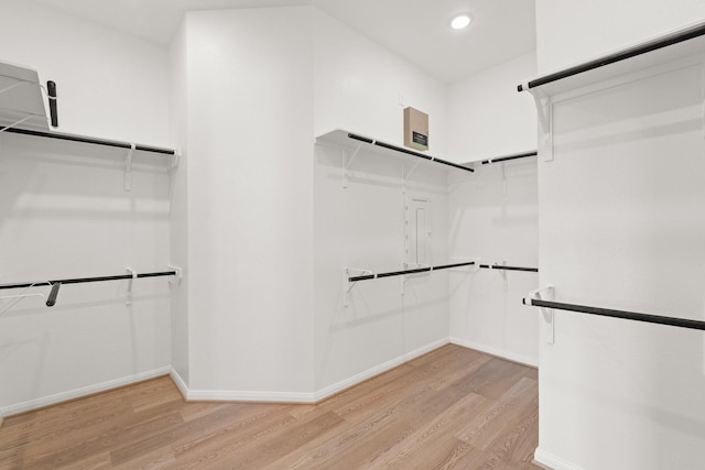 spacious closet with light hardwood / wood-style floors