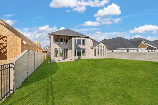 back of house featuring a yard