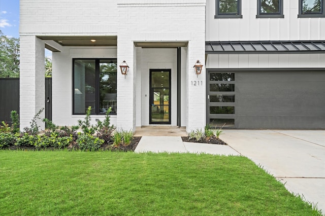 property entrance featuring a yard and a garage