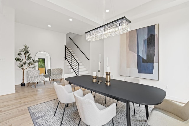 dining space featuring light hardwood / wood-style flooring and an inviting chandelier