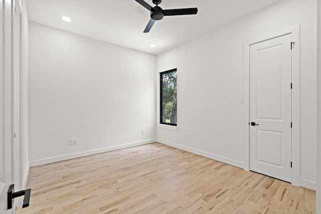 unfurnished room with ceiling fan and light wood-type flooring