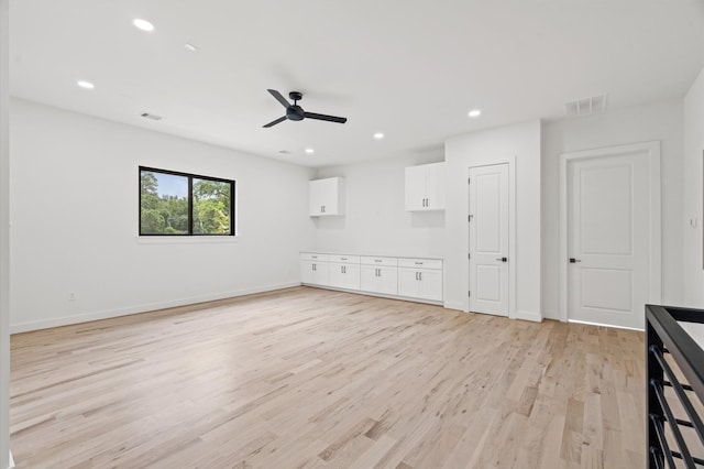 unfurnished living room with ceiling fan and light hardwood / wood-style flooring