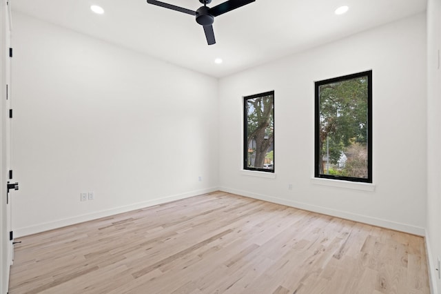 spare room with ceiling fan and light wood-type flooring