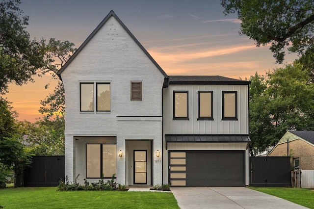 contemporary home with a garage and a yard