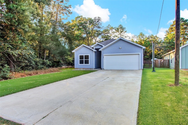 view of front of home with a garage and a front lawn