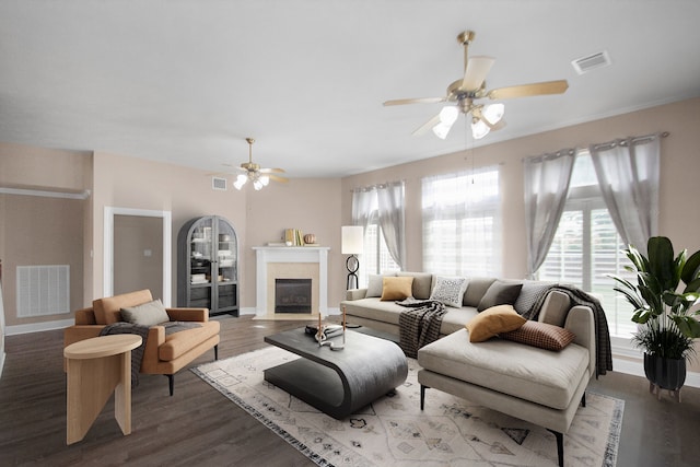 living room with dark wood-type flooring and ceiling fan