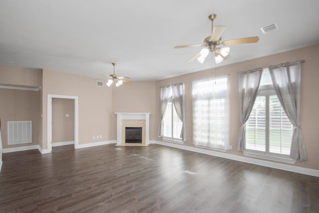 unfurnished living room featuring dark hardwood / wood-style flooring, ceiling fan, and plenty of natural light