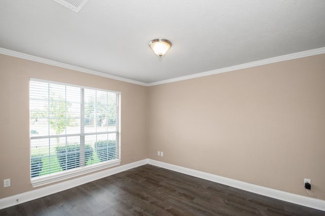 empty room featuring dark wood-type flooring and crown molding