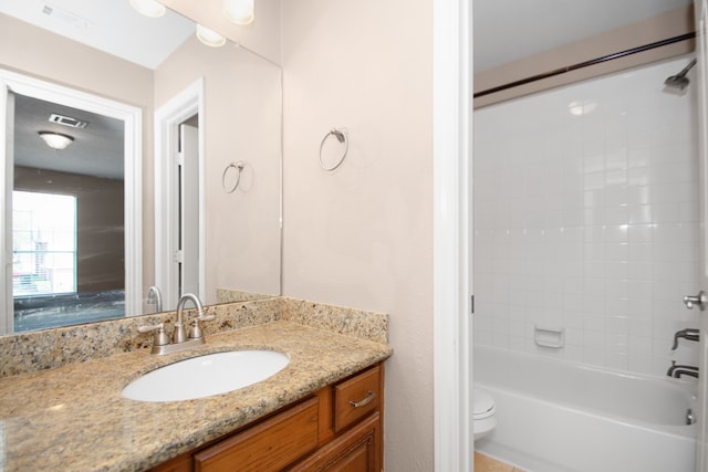 full bathroom with vanity, toilet, and tiled shower / bath combo