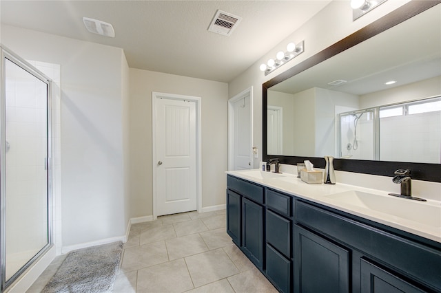 bathroom with vanity, a shower with shower door, and tile patterned flooring